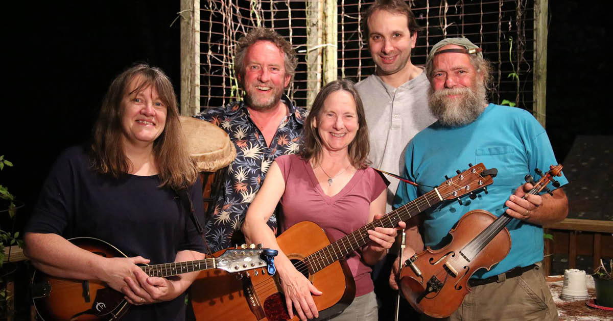 snow-crow_600x600 Five band members of Snow Crow pose and smile with their instruments